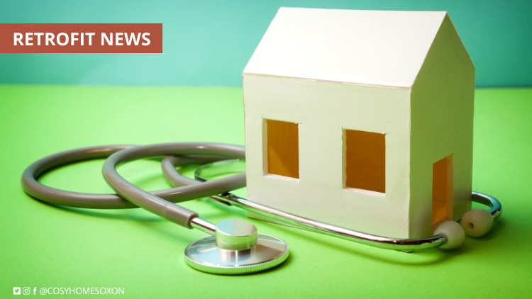 A model house wrapped in a Doctor's  stethoscope