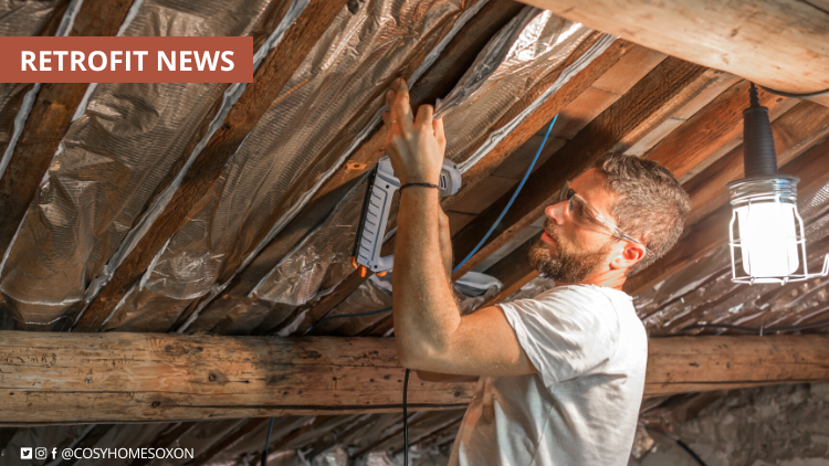 A man installing insulation in a loft