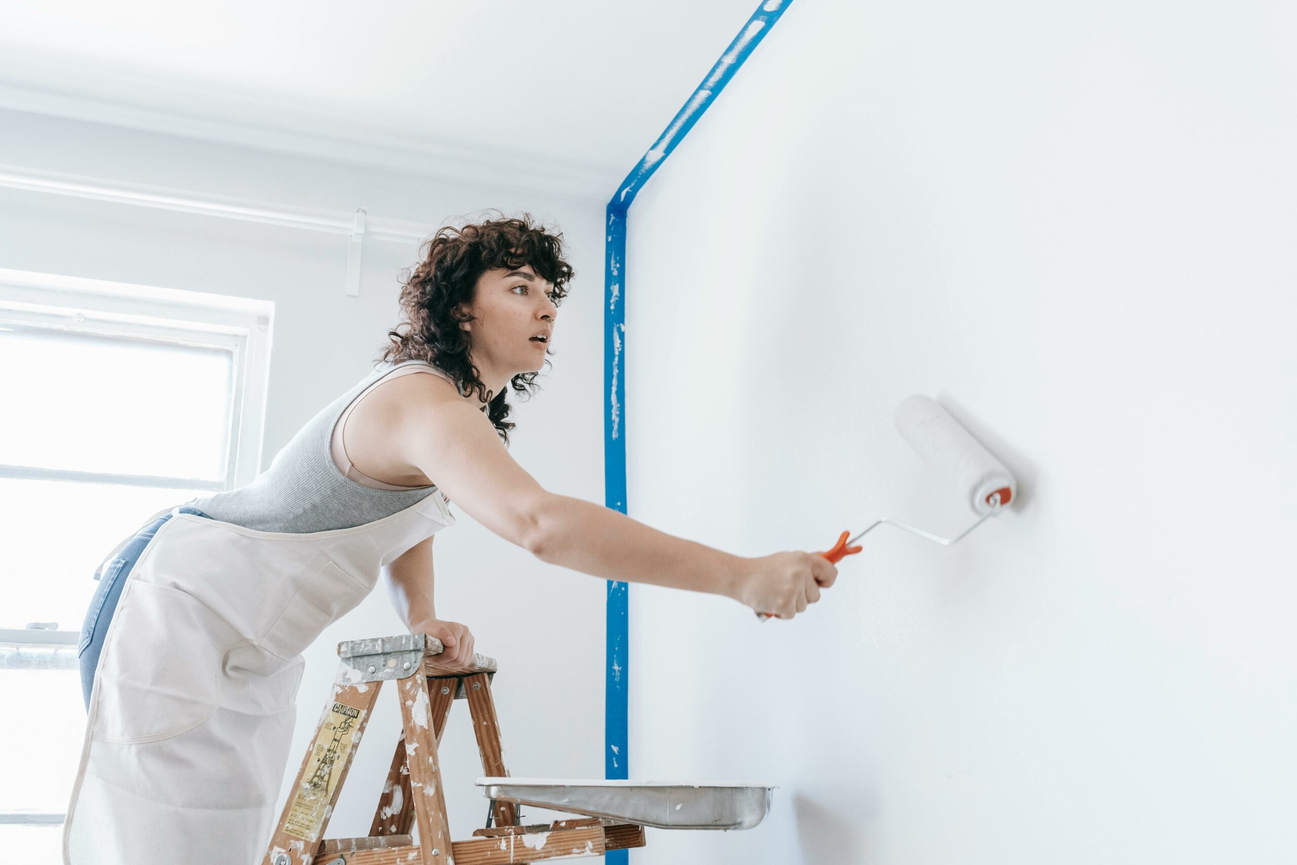 woman painting wall